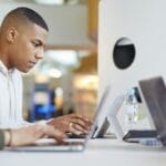 University students using laptops and digital tablet, working together