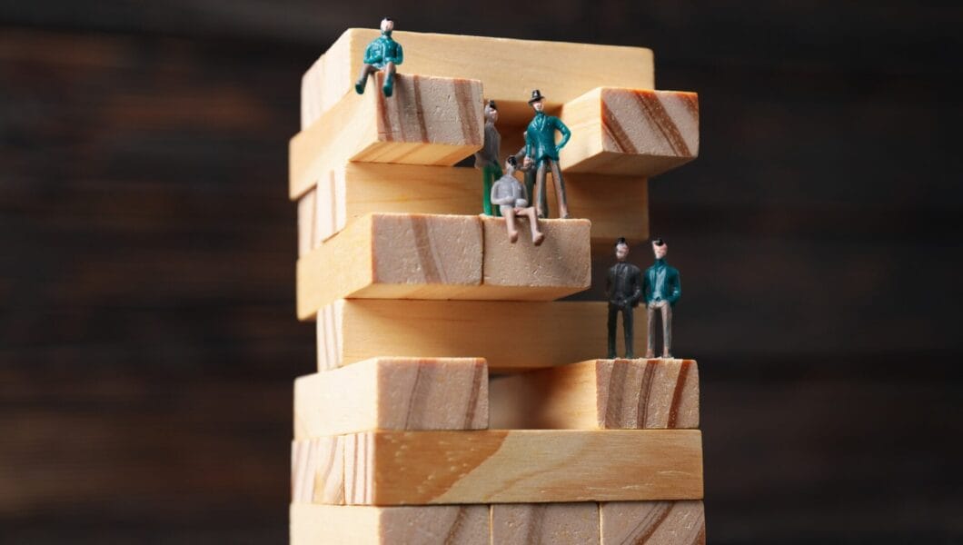 High-rise building design concept, jenga game, on dark background.