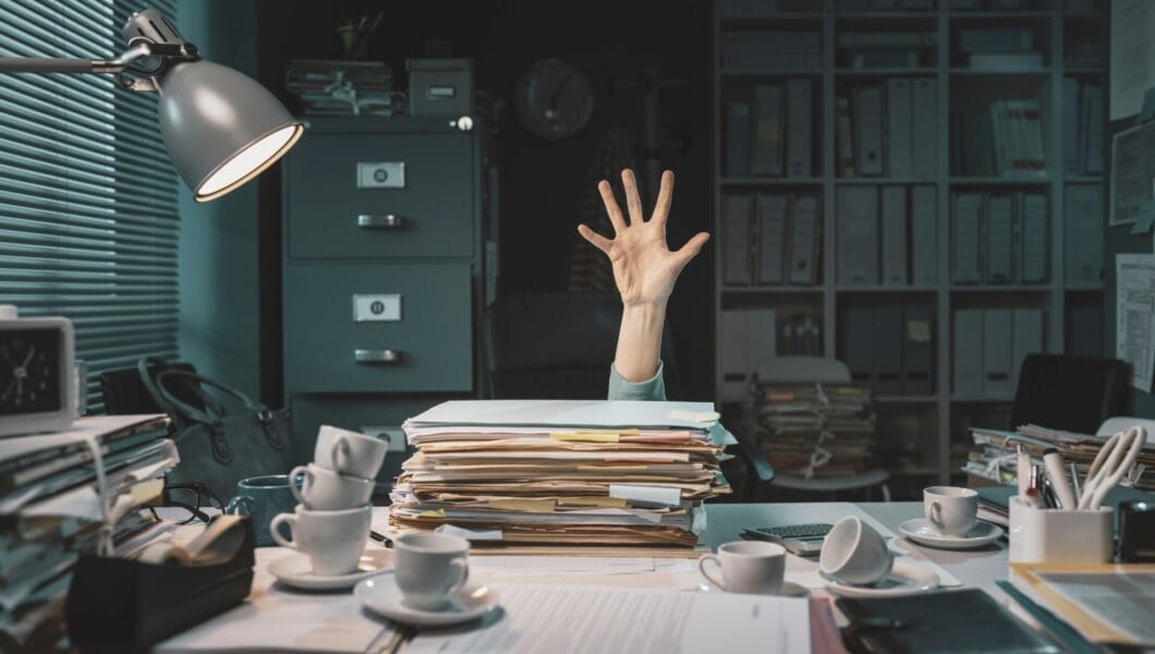 Office worker overwhelmed with paperwork